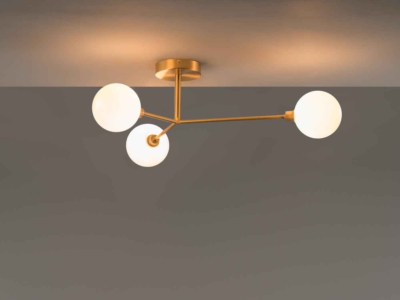 3 light flush ceiling light by houseof. product shot lights on dimmed #colour_brass